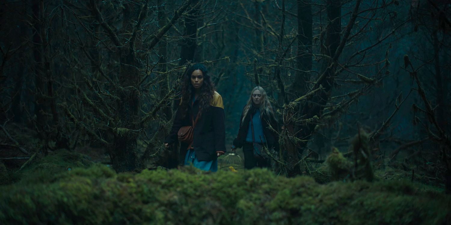 Mina (Dakota Fanning) and Ciara (Georgina Campbell) walk deep into the forest in The Watchers