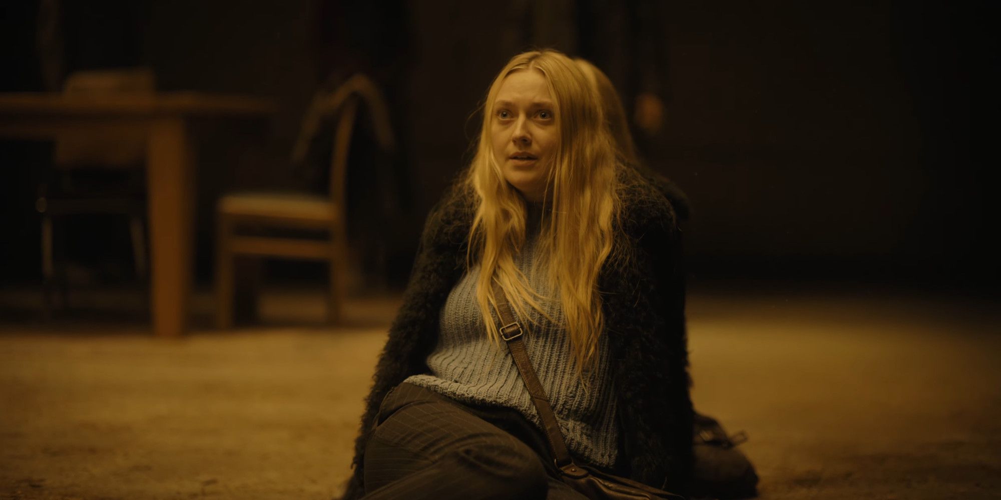 The Watchers Dakota Fanning sits on a rug in lookig concerned 