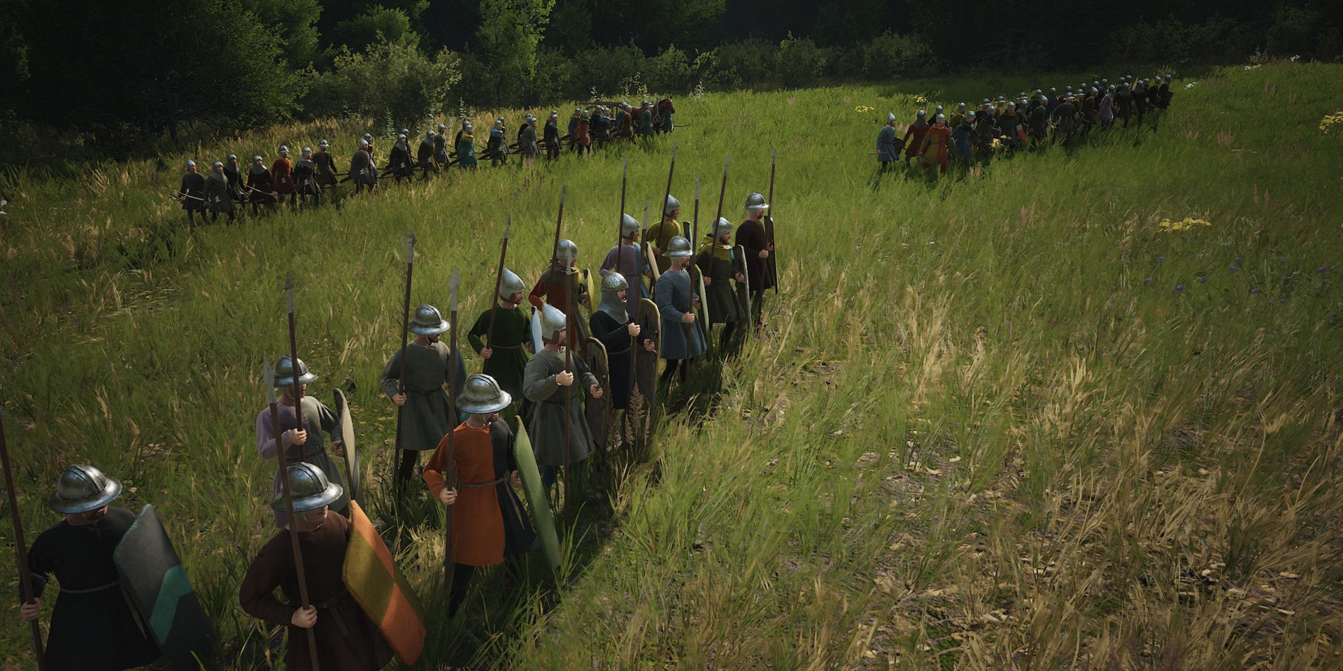 Três milícias em formação compacta estão em um campo gramado em uma captura de tela de Manor Lords.