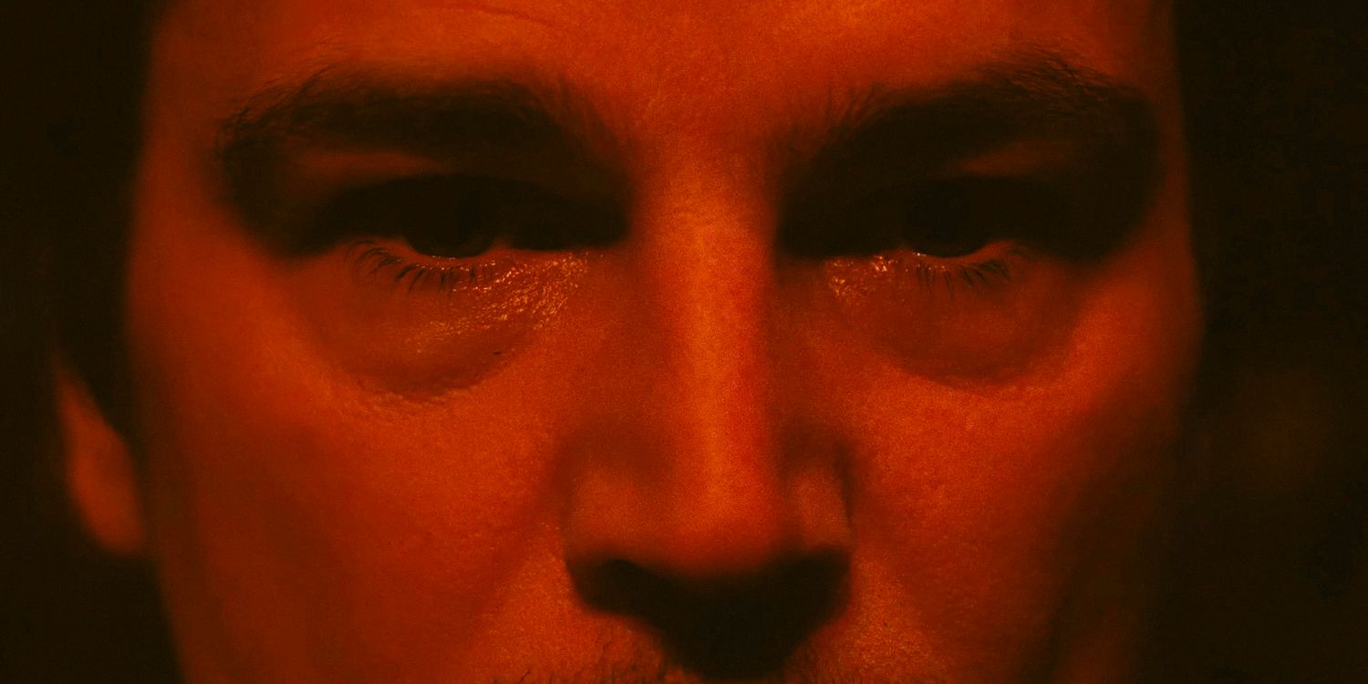 Close-up of Cooper's gaze illuminated by a red light in Trap