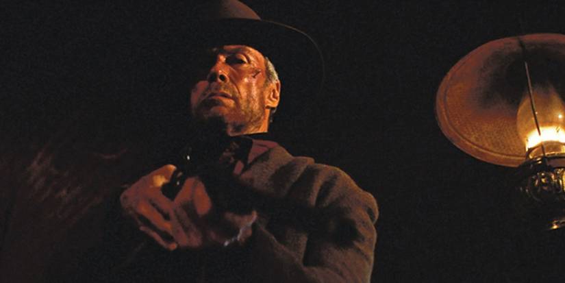 Will Munny aiming a shotgun down in Unforgiven