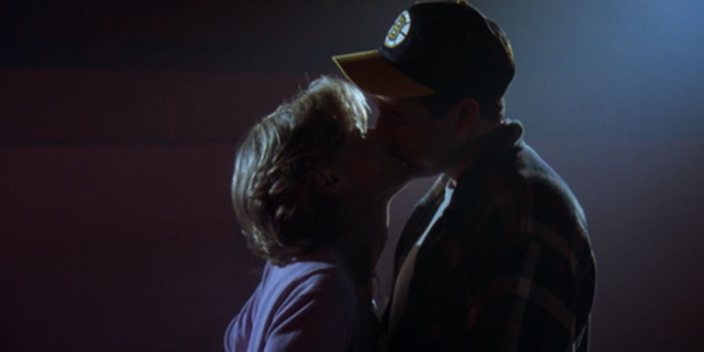 Happy and Virginia kissing in the dark at the hockey rink in Happy Gilmore