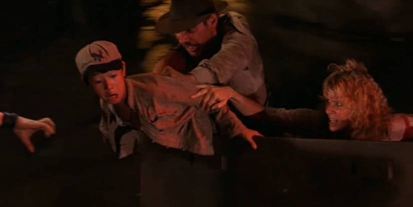 Indy and Willie trying to pull Short Round back into the cart in Indiana Jones And The Temple Of Doom 