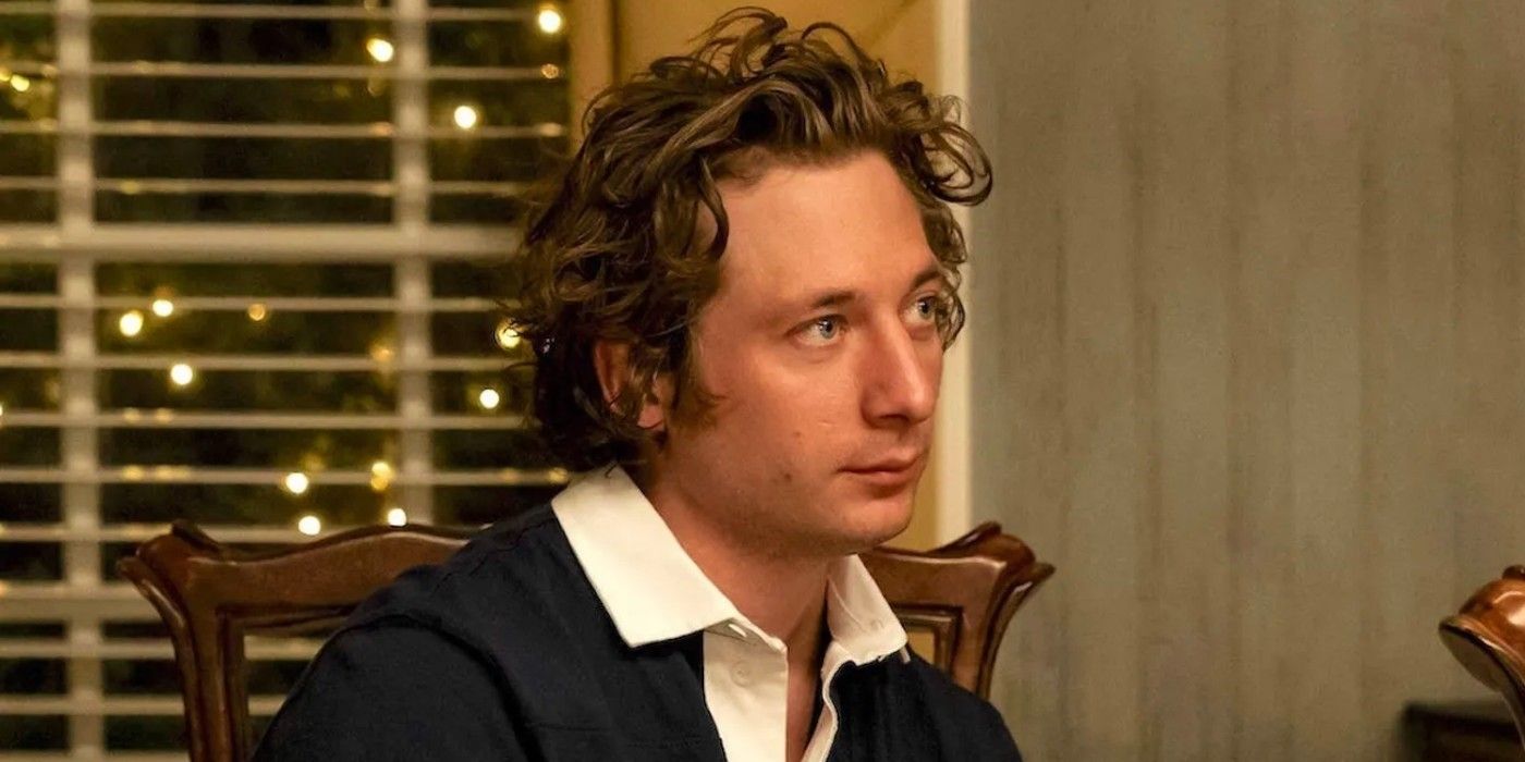 Jeremy Allen White as Carmy in The Bear season 2 episode 6 "Fishes" sitting at the dinner table