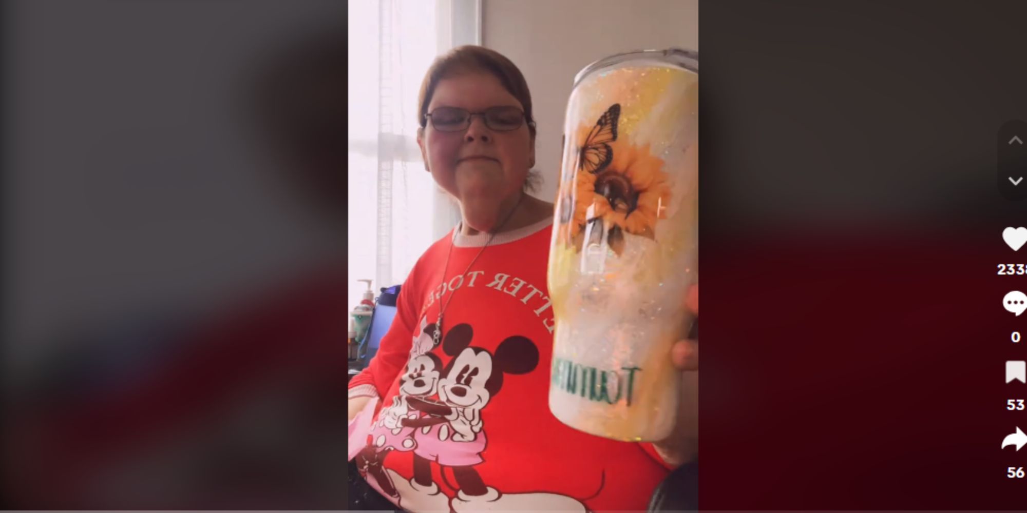1000-lb Sisters Tammy Slaton unboxing a tumbler, wearing a red Disney graphic tee shirt