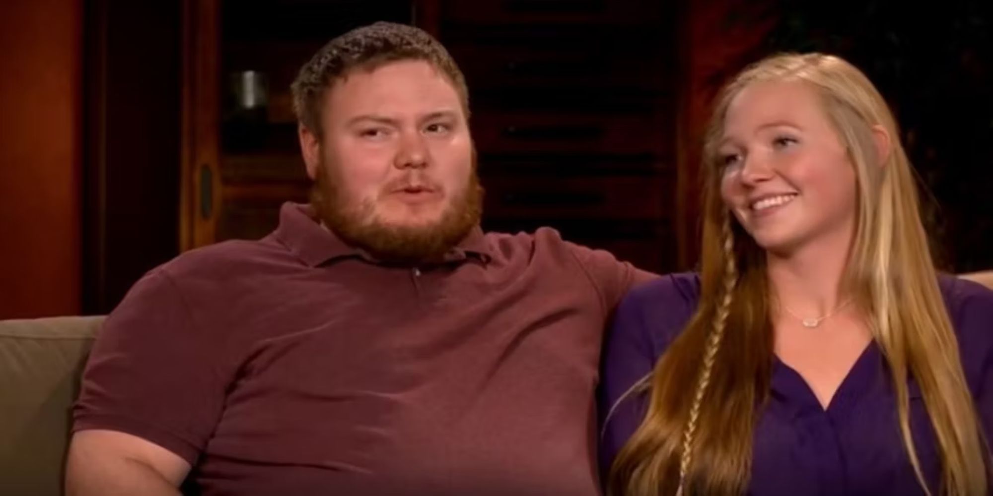 Sister Wives Aspyn Brown & Mitchell Thompson seated side by side on a couch in an interview