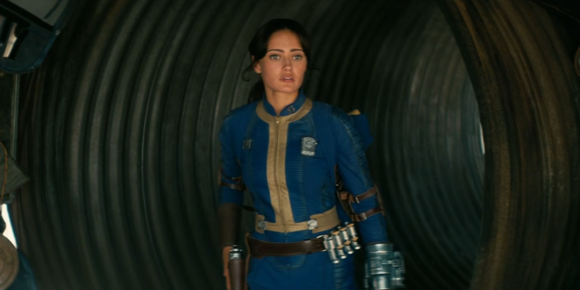 Ella Purnell as Lucy MacLean walking down a tunnel in Fallout