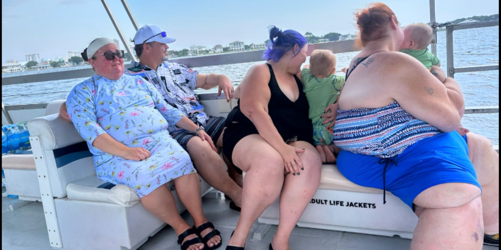 1000-lb Sisters Chris Combs, Brittany Combs sit nearby as Tammy Slaton & Amy Slaton hold Glenn Halterman & Gage Halterman on a boat