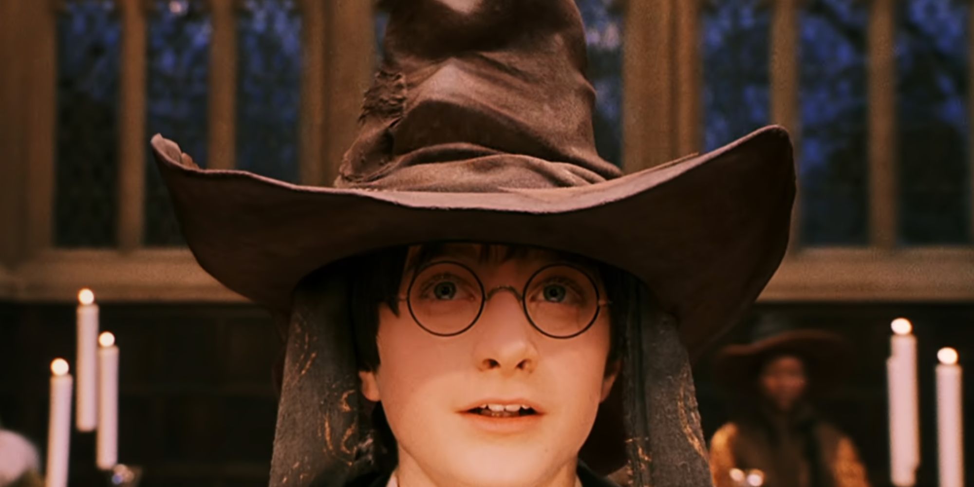 Daniel Radcliffe as Harry Potter in the first movie with the Sorting Hat on his head