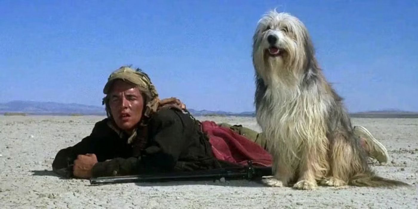 Vic deitado na areia com seu cachorro em A Boy and His Dog