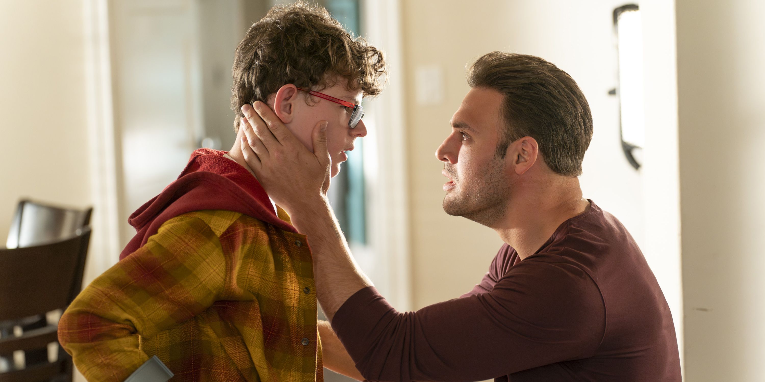 Eddie (Ryan Guzman) holding Christopher's (Gavin McHugh) face in the 9-1-1 season 7 finale.