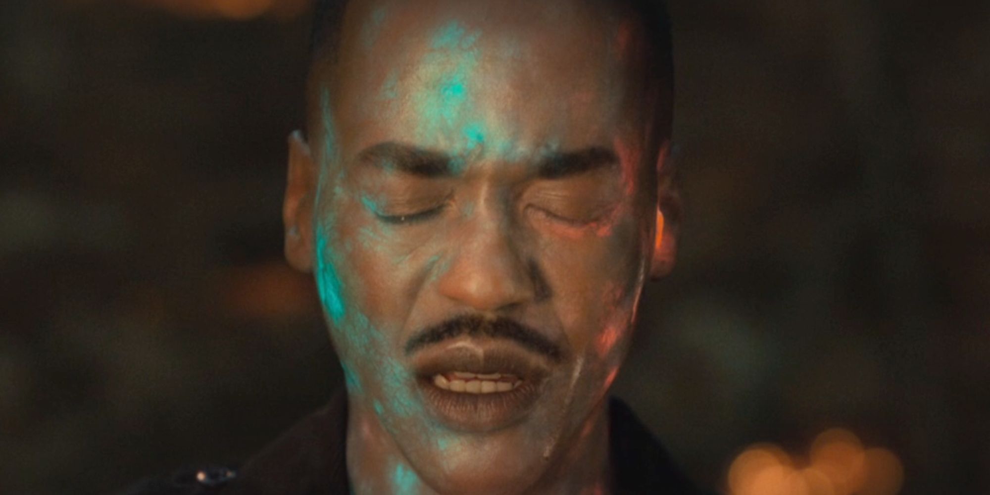 Ncuti Gatwa with his eyes closed as his skin glows blue as the Doctor in Doctor Who.