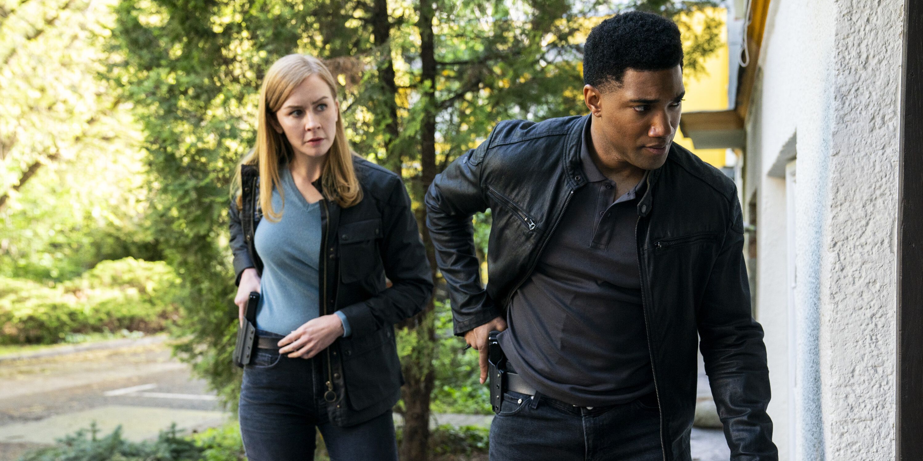 Eva-Jane Willis as Europol Agent Megan “Smitty” Garretson and Carter Redwood as Special Agent Andre Raines approaching a door in FBI: International season 3, episode 11