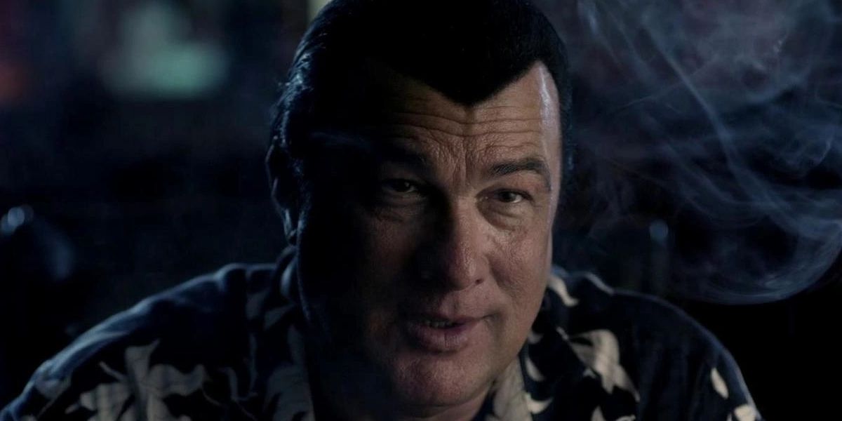 Steven Seagal smoking at a table in Gunshot Straight