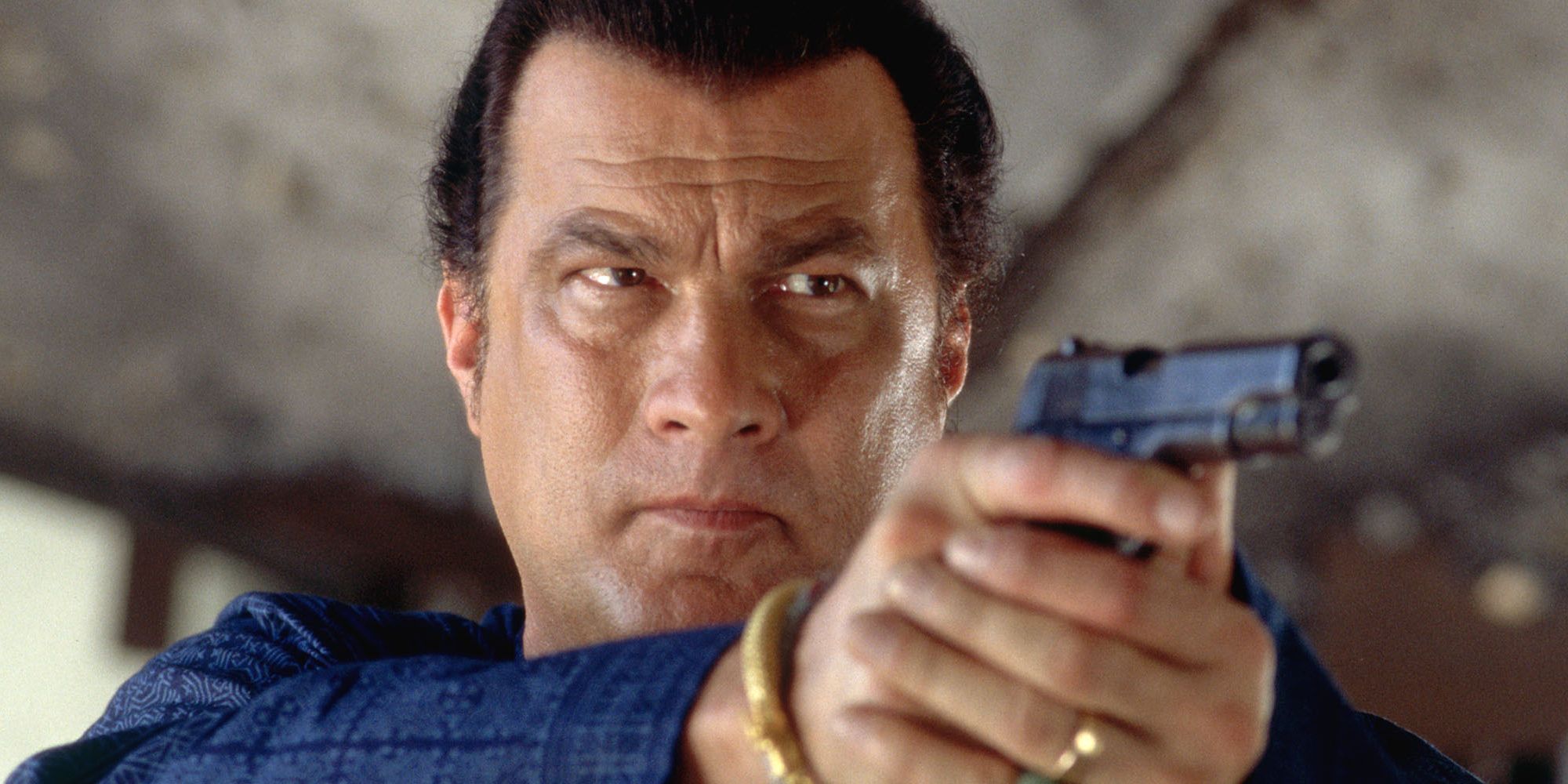 Steven Seagal aiming a gun in Driven to Kill