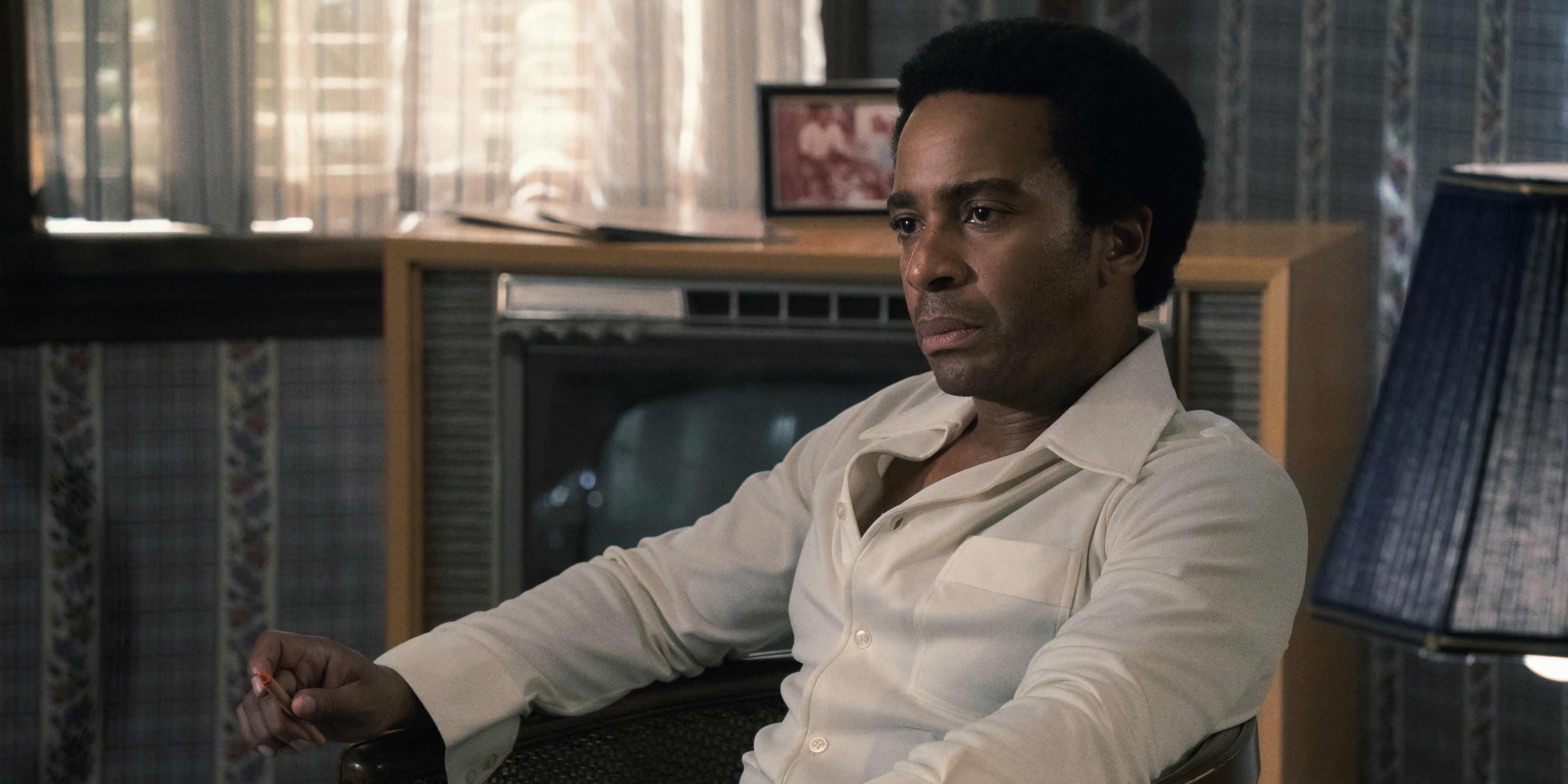 Andre Holland sits in The Big Cigar still
