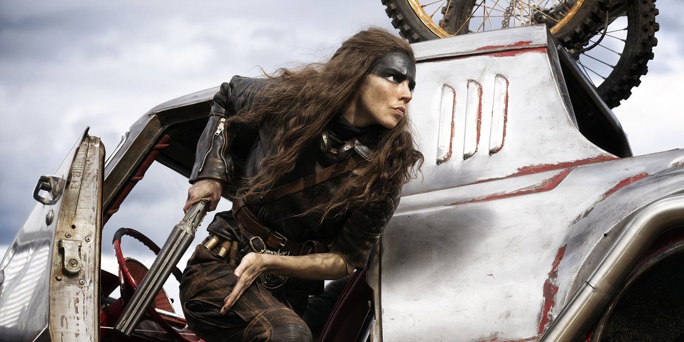 Anya Taylor-Joy surging out of the side of a vehicle with a weapon in hand in Furiosa A Mad Max Saga