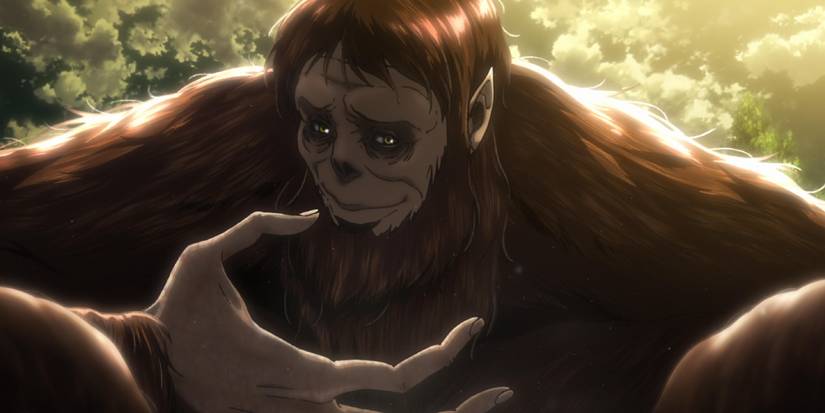 Attack on Titan's Beast Titan looks at his hand with a weird sort of smile on his face.