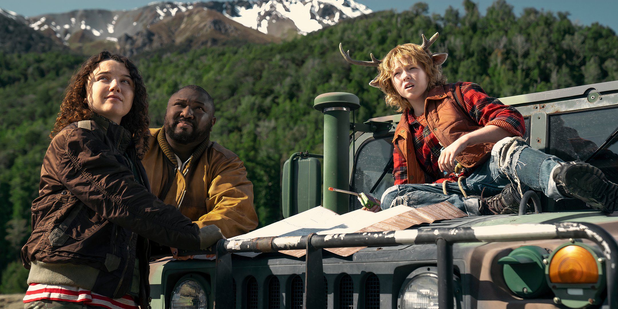 Bear, Big Man and Gus looking at the mountains while on a Jeep in Sweet Tooth season 3