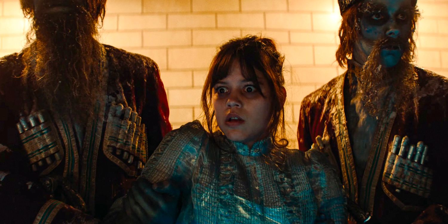 Astrid (Jenna Ortega) with a look of fright is taken by the arms by two guards in Neverworld in Beetlejuice 2