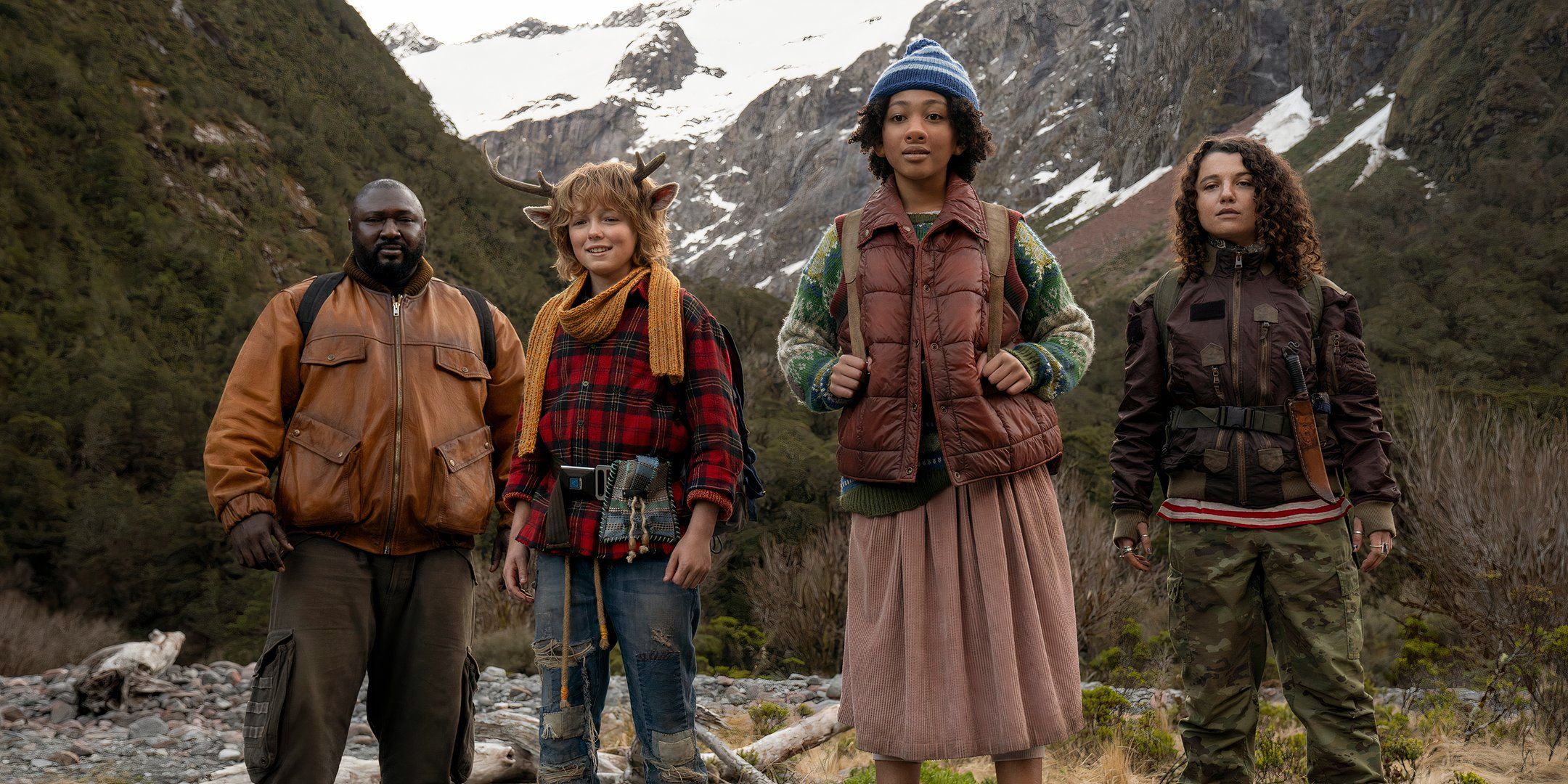 Big Man, Gus, Wendy and Bear standing and smiling in the mountains in Sweet Tooth season 3