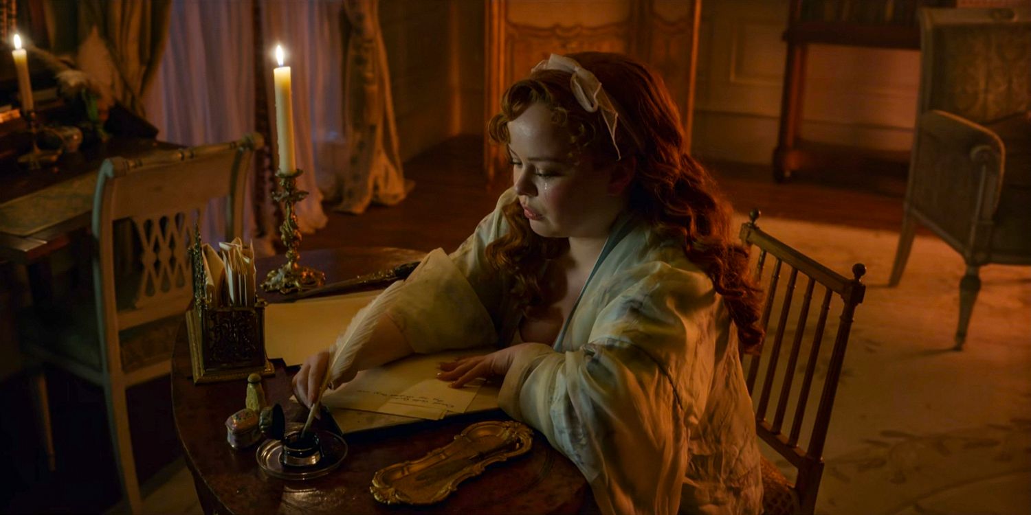 Penelope (Nicola Coughlan) with tears falling from her eyes writing a letter in Bridgerton season 3 Part 1