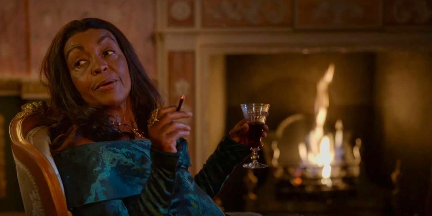 Lady Agatha Danbury (Adjoa Andoh) smoking a cigar and holding a glass of liquor in Bridgerton season 3 Part 1