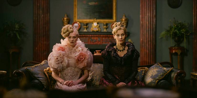 Cressida Cowper (Jessica Madsen) and Lady Cowper (Joanna Bobin) very serious, sitting next to each other in Bridgerton season 3 Part 1