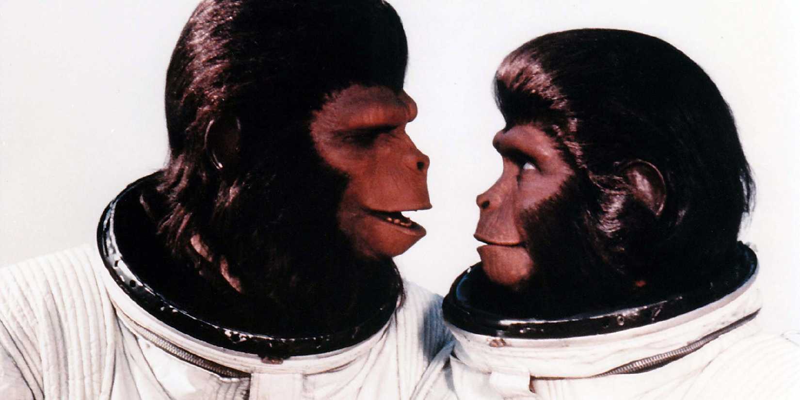 Cornelius and Zira wearing spacesuits and looking at each other in Escape from the Planet of the Apes