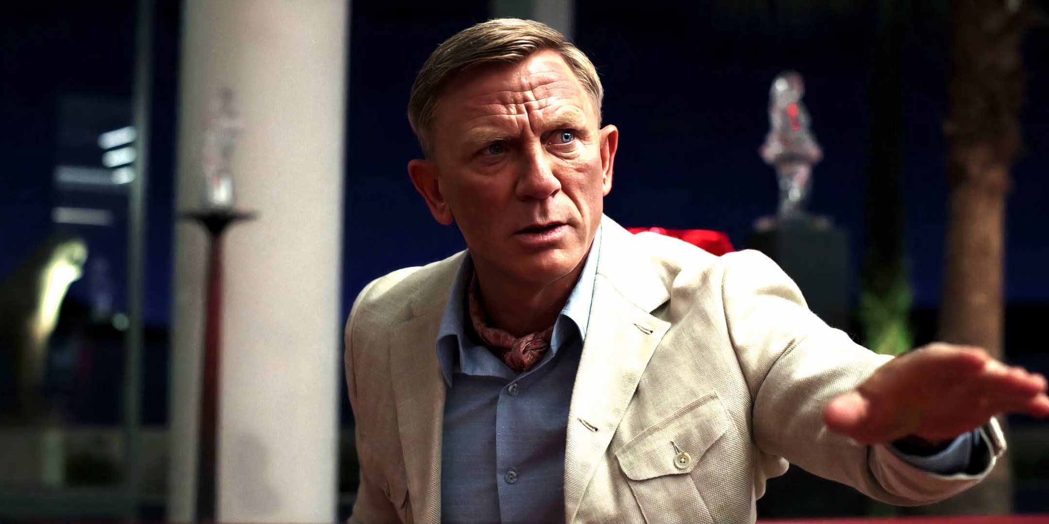 Daniel Craig as Benoit Blanc trying to calm everyone down in Glass Onion A Knives Out Mystery.