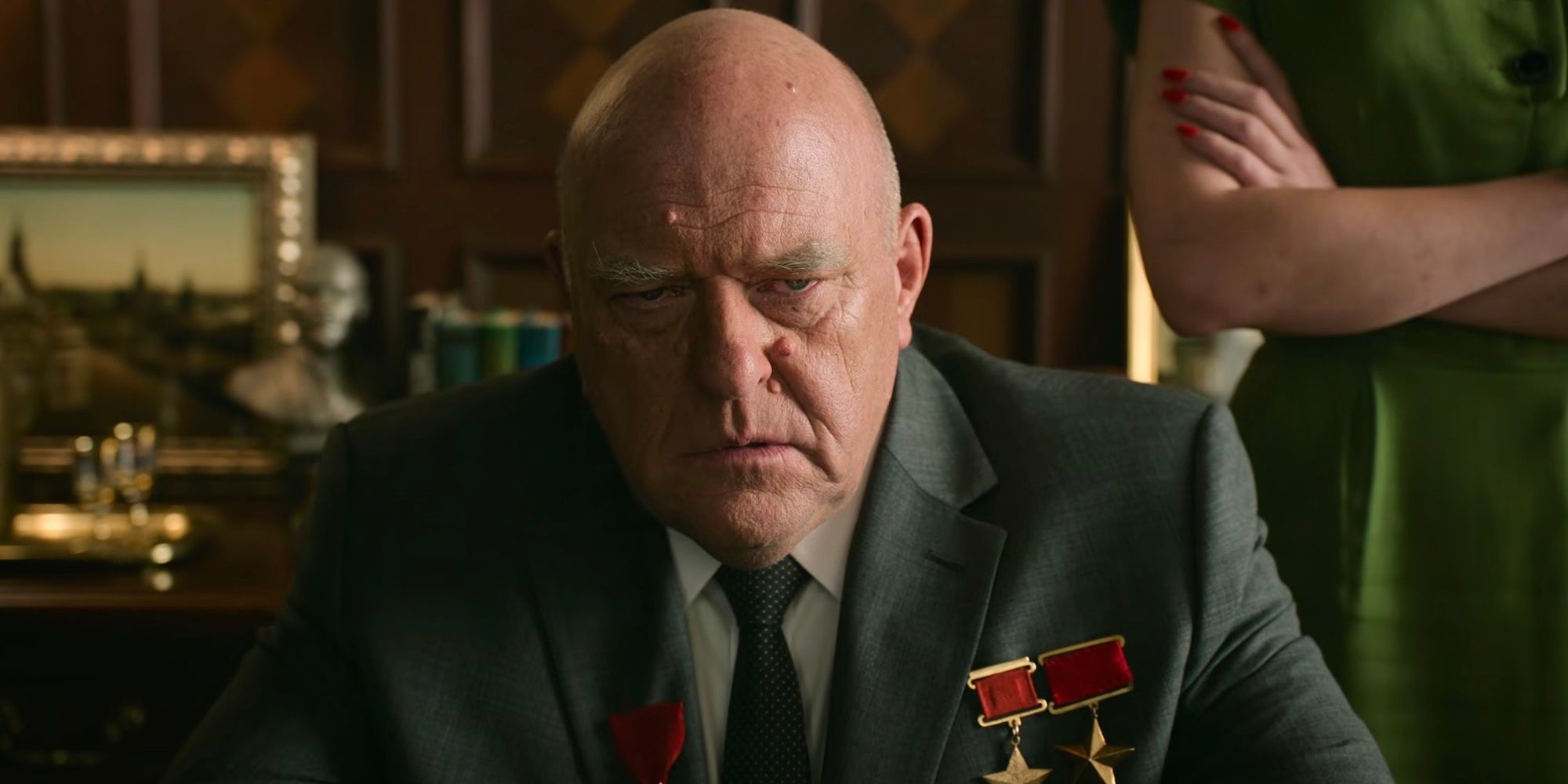 Dean Norris looks forward with an angered expression. 
