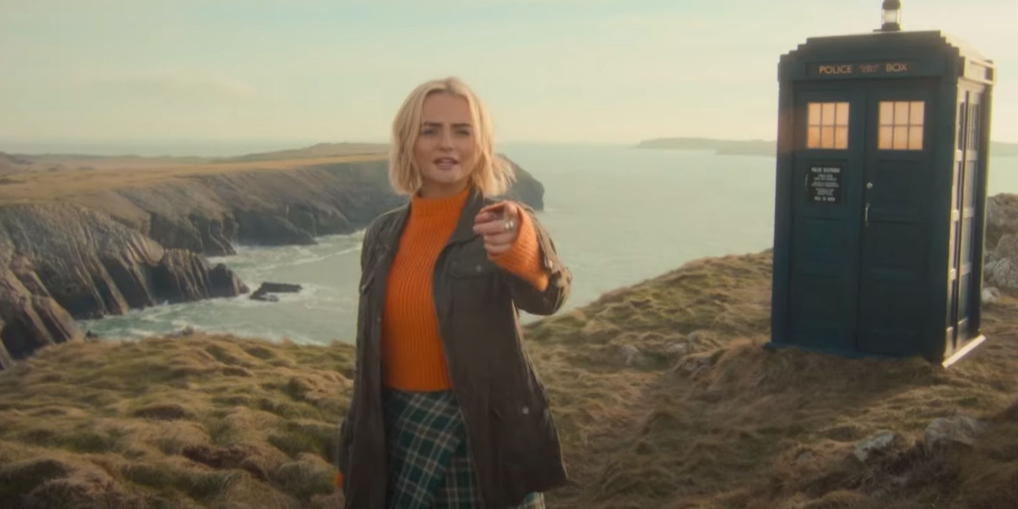 Millie Gibson as Ruby Sunday pointing on a cliff in Doctor Who.