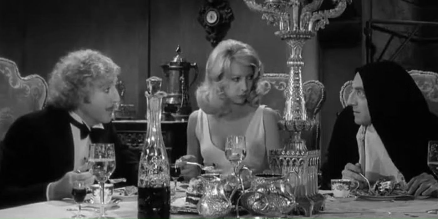 Dr Frankenstein (Gene Wilder), Inga (Teri Garr), and Igor (Marty Feldman) sitting together at a dinner table in Young Frankenstein