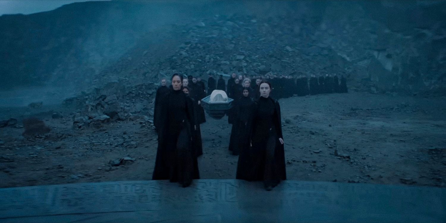 Members of the Bene Gesserit Sisterhood carrying a body during a procession in Dune Prophecy