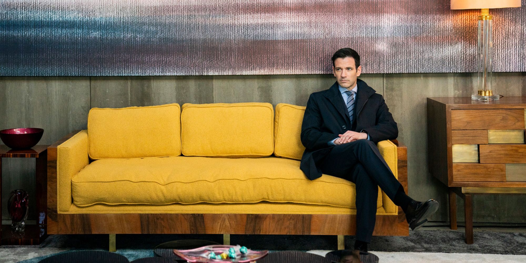 Brian Lange (Colin Donnell) relaxes on a sofa on FBI: International season 3