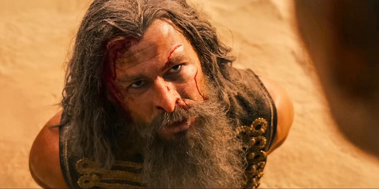 Chris Hemsworth as Dr. Dementus with wounds on his face in Furiosa: A Mad Max Saga