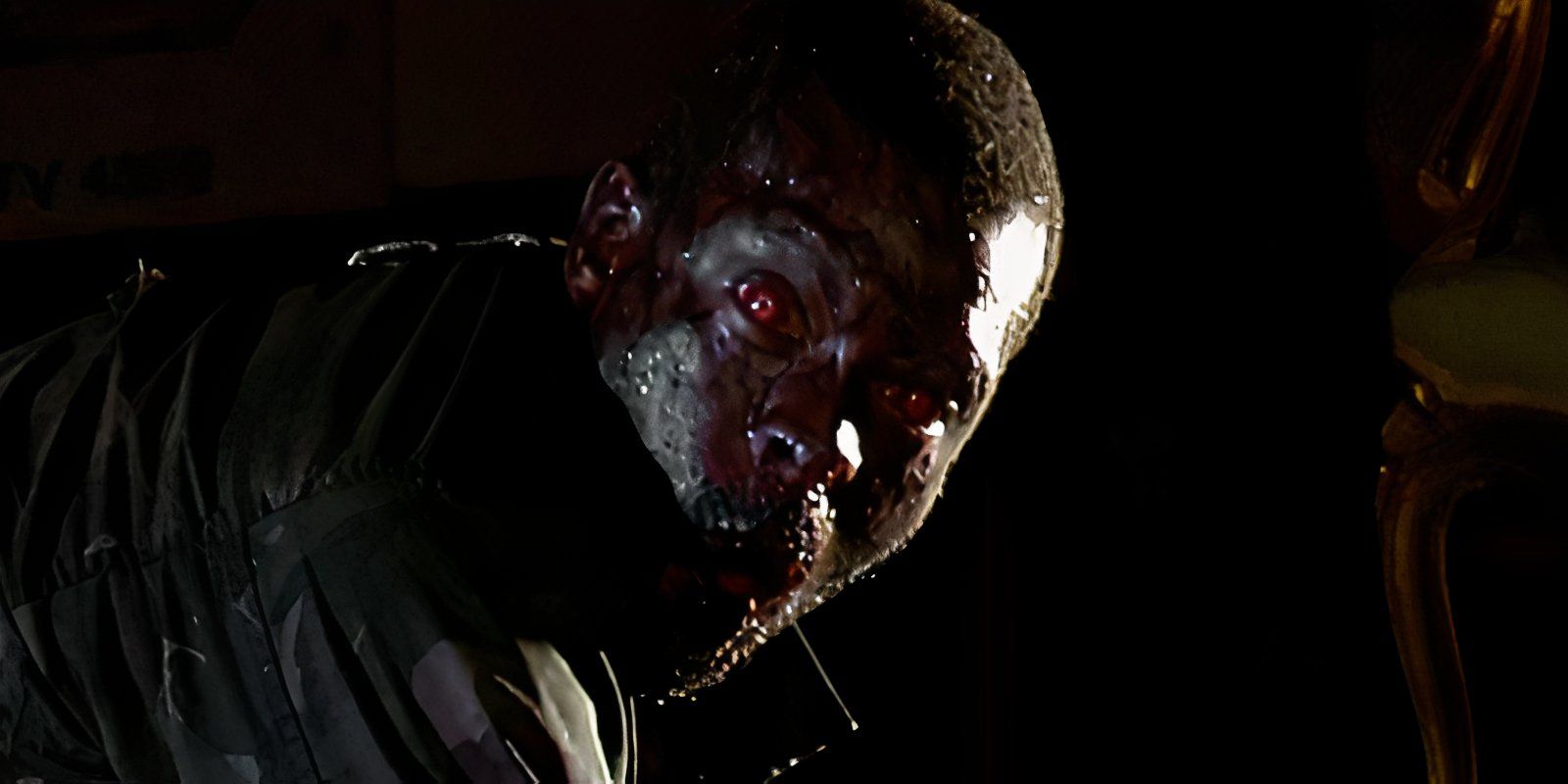 A sweaty Red Eyed Zombie in 28 Days Later stares at camera