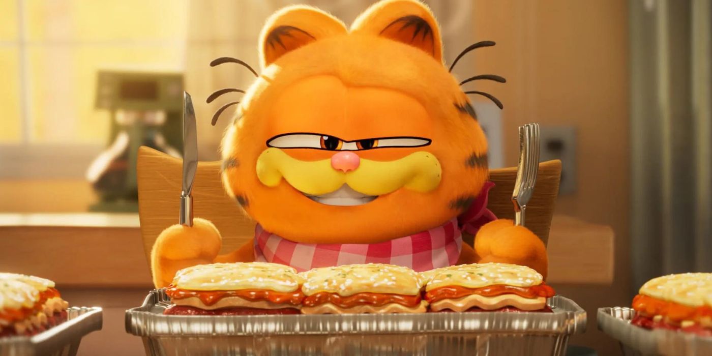 Garfield (Chris Pratt) grins over a tray of lasagna in The Garfield Movie