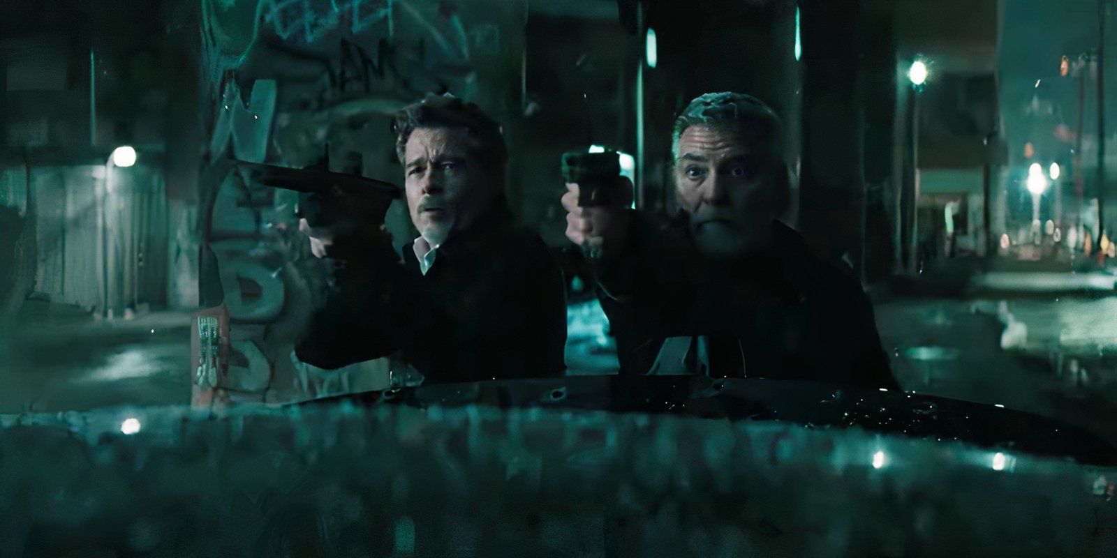 George Clooney and Brad Pitt shooting guns in Wolfs