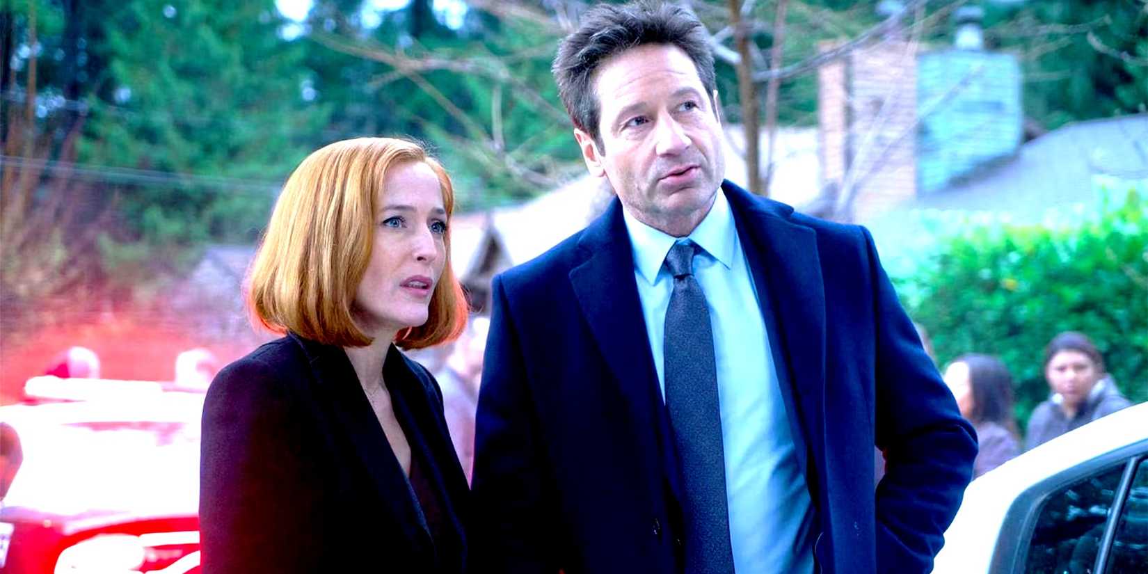 Gillian Anderson as Scully and David Duchovny as Mulder standing by flashing lights at a crime scene in The X-Files season 11.