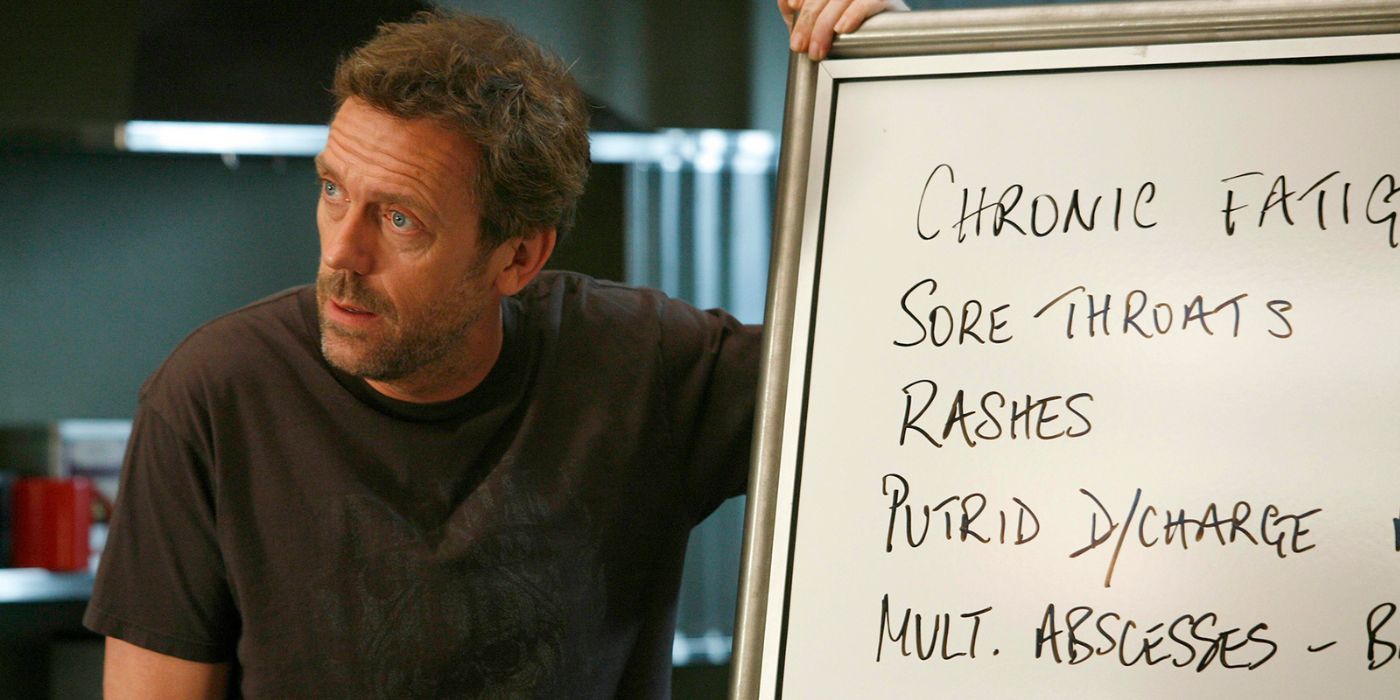 House (Hugh Laurie) looking dismissive at the white board in House