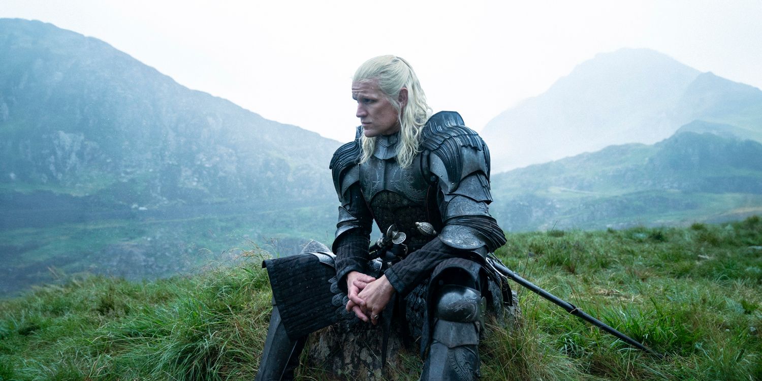 Prince Daemon Targaryen (Matt Smith) in armor sitting on a rock looking pensive in House of the Dragon season 2