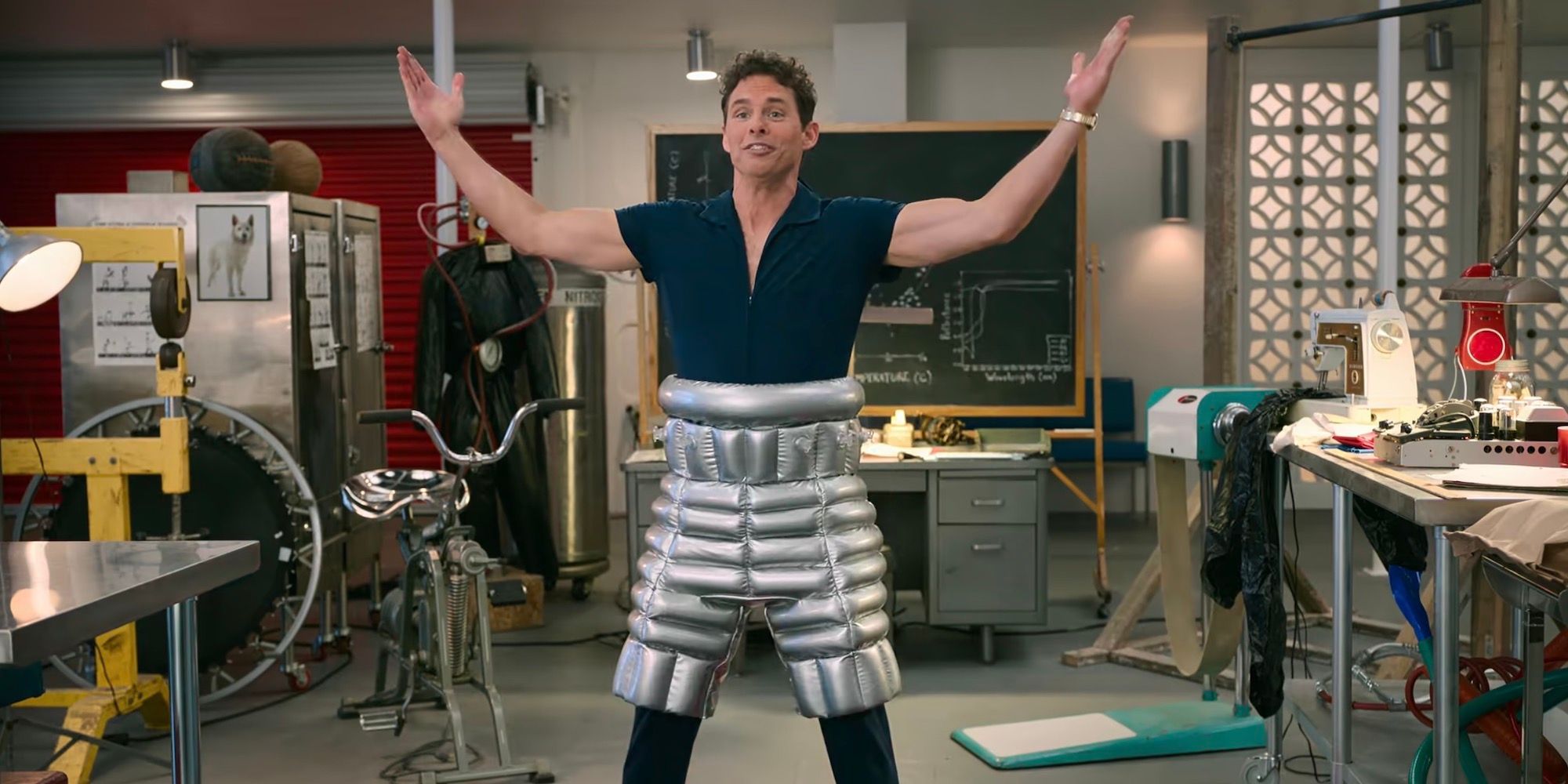 James Marsden holds his arms out while wearing foil pants.