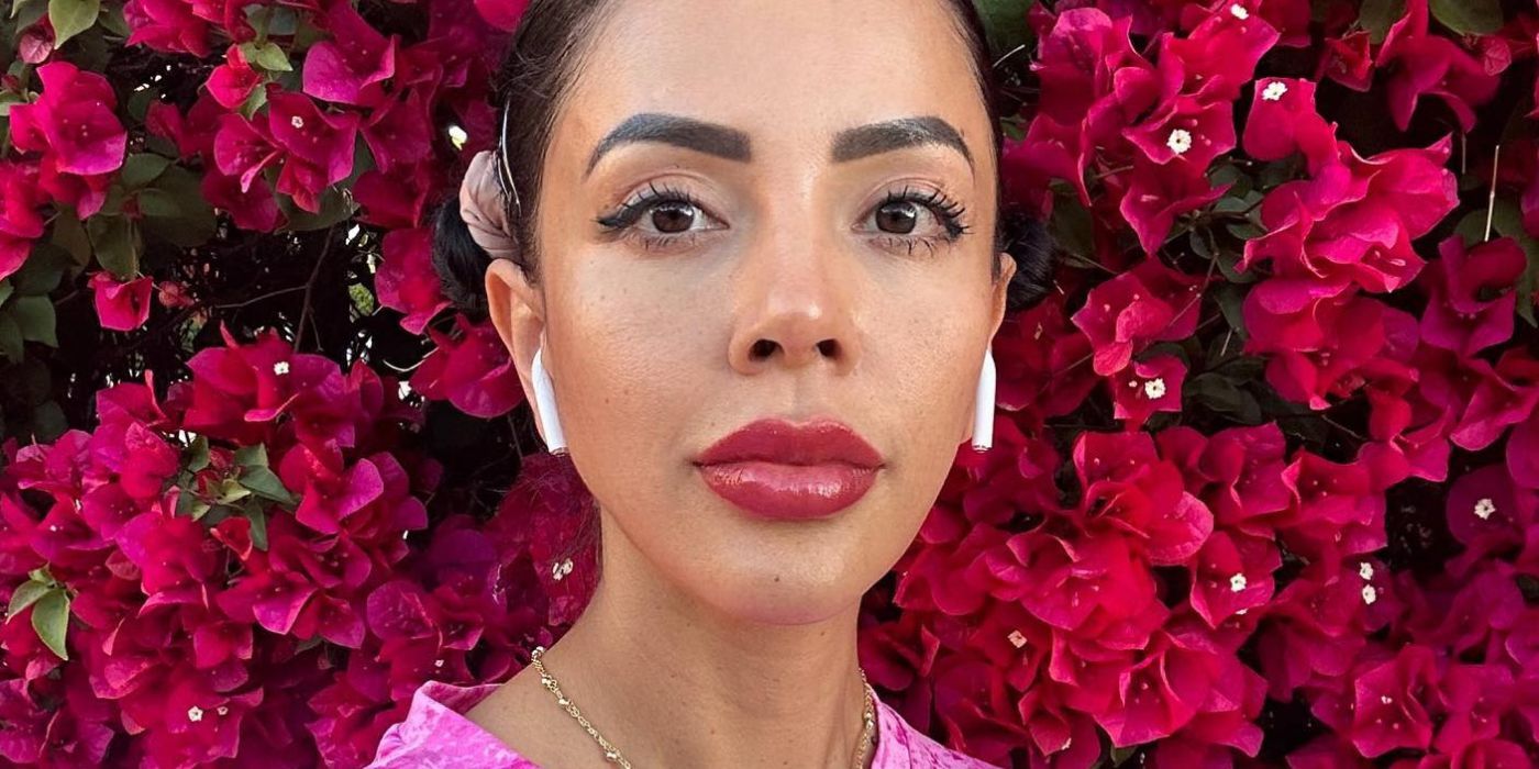 Jasmine Pineda In 90 Day Fiance in pink dress and tied up hair with pink flowers in the back