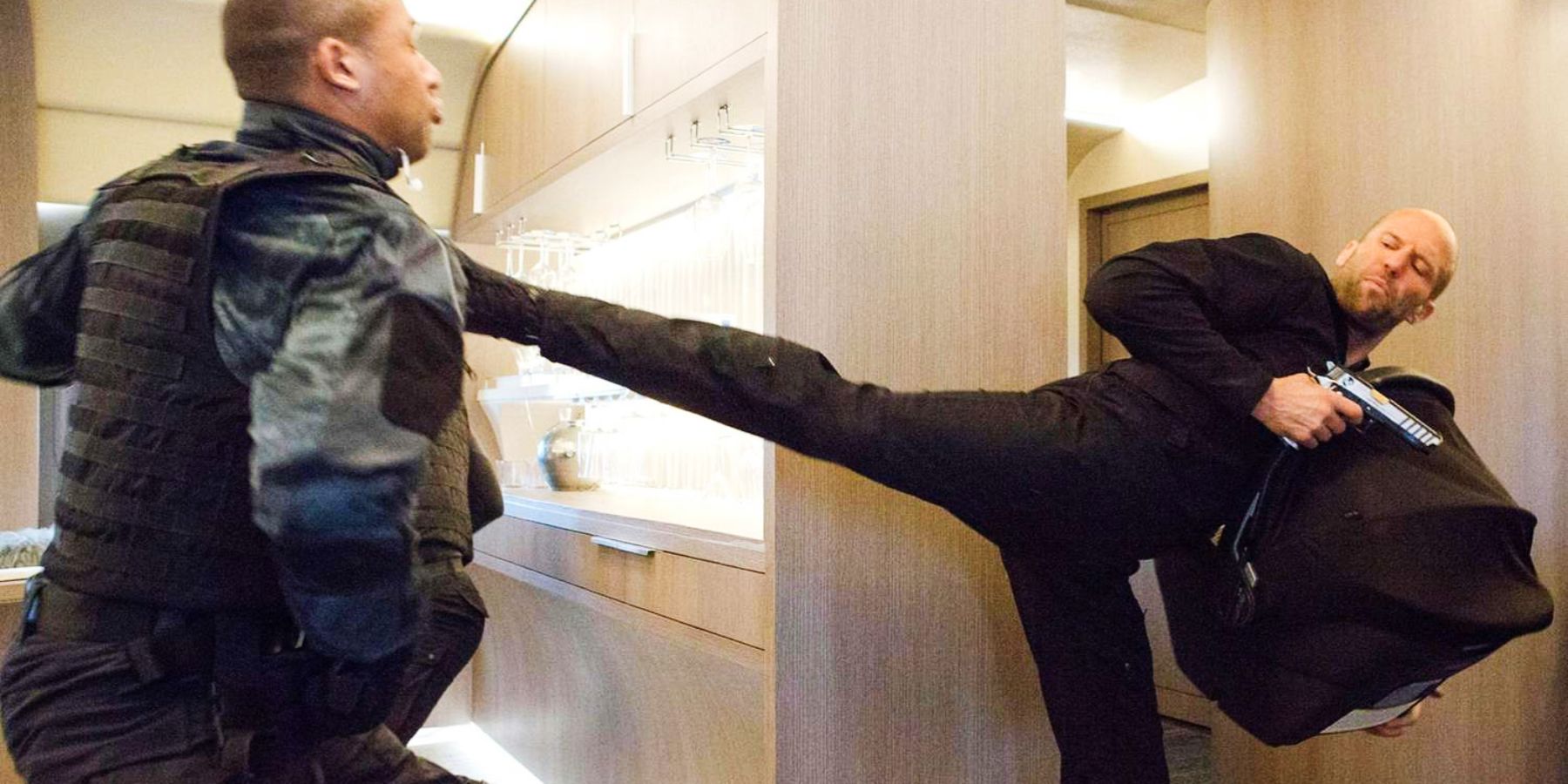 Jason Statham's Deckard Shaw kicking vested man in Fate of the Furious