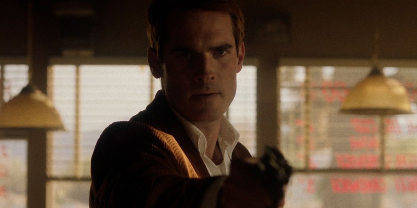 Jim Cummings as The Knife Salesman aiming a gun in The Last Stop in Yuma County