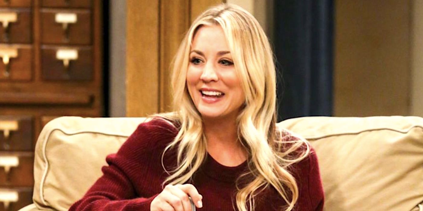 Kaely Cuoco's Penny smiling while eating on the couch in The Big Bang Theory
