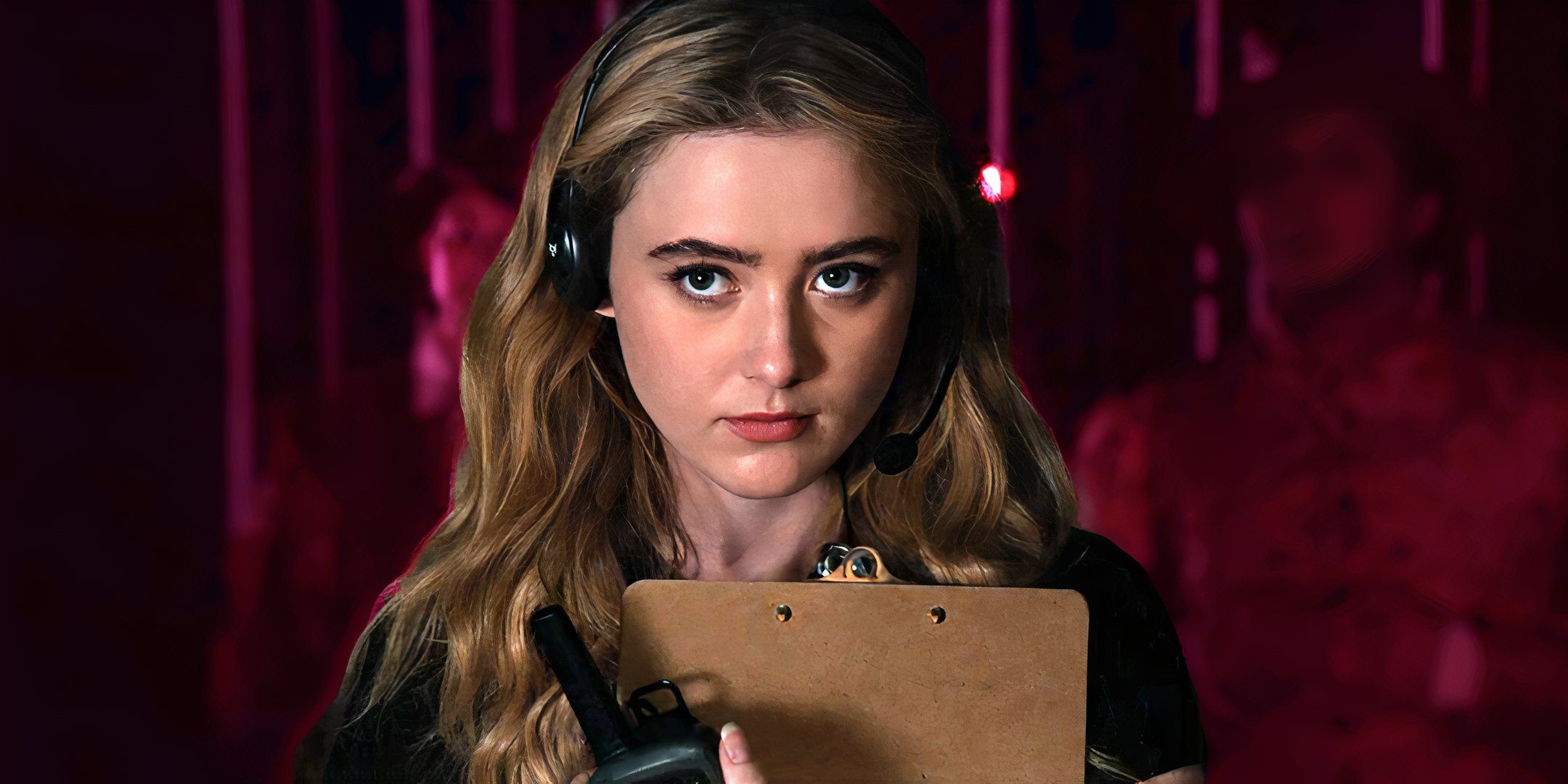 Kathryn Newton as Allie looking serious and holding a clipboard in The Society