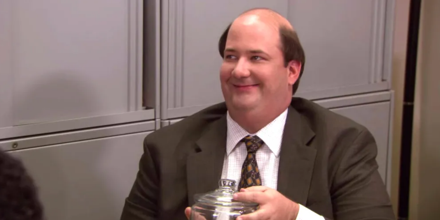 Kevin Malone holding a jar of candy on the Office