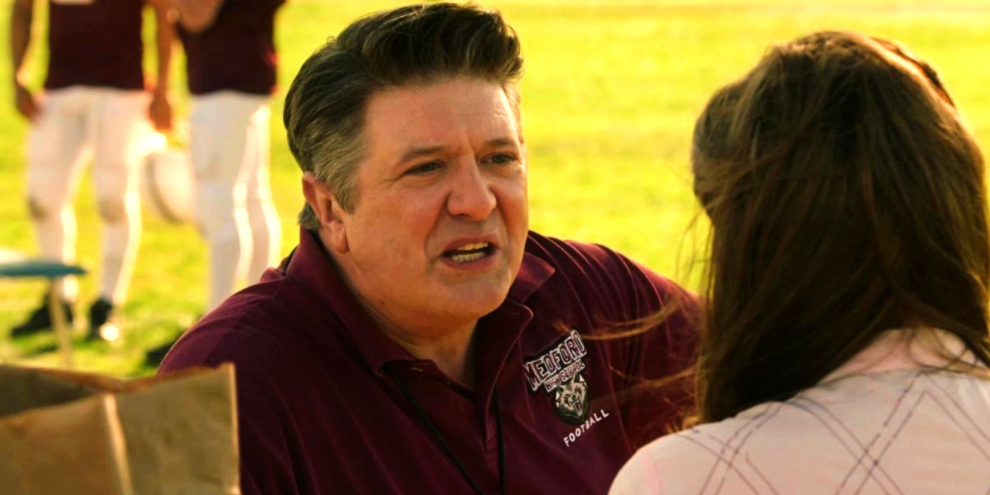 Lance Barber as George talking on the football field in Young Sheldon